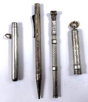 A silver propelling pencil with seal top, calculator and other silver propelling pencils