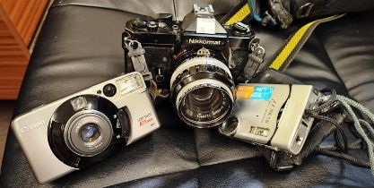 A vintage Nikkormat SLR film camera with Nikon Nikkor-S lens 1:14 F = 50mm with Canon Sure Shot
