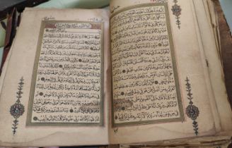 A late 19th/early 20th century Quran Arabic text with gilt and other highlights all backed on