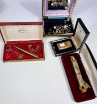 A Dunhill lighter, boxed; an onyx and gilt cigar cutter; a pen and cufflinks presentation set; other