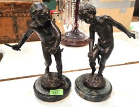 After August Moreau, a pair of bronze figures of young boys playing, mounted on circular marble