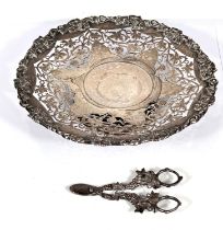 A hallmarked silver shallow dish with relief and pierced vine decoration, on circular foot,