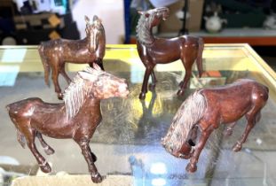 Four Chinese Wang Mu style carved wooden horses with fine details in various positions, height 13cm