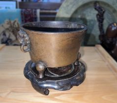 A Chinese bronze censor on fitted wooden stand, handles to each side, ht. 9cm (without stand)