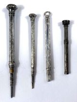 Four miniature silver/white metal propelling pencils, three with seal tops