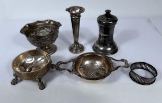 A hallmarked silver tea strainer on stand; a hallmarked silver pepper grinder; glass salt; etc., 6.