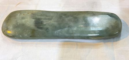 A Chinese 17th/18th century jade rounded rectangular scholars wrist rest, length 39cm