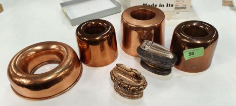 A selection of copper jelly moulds, some named two plated table lighters