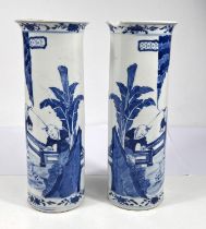 A pair of 19th century blue and white sleeve vases with traditional decoration of domestic scenes