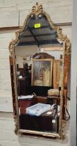A wall mirror in the French manner with gilt frame and peach border, and a large cream framed