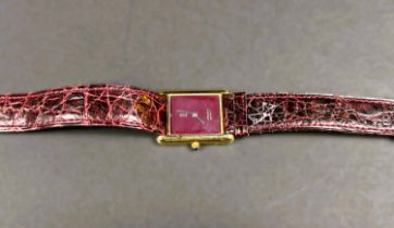 A ladies "Must De Cartier" tank watch with burgundy dial, sapphire set winder on brown leather strap