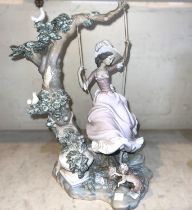 A large Lladro group:  girl on swing, (missing right lower leg) ht. 43cm