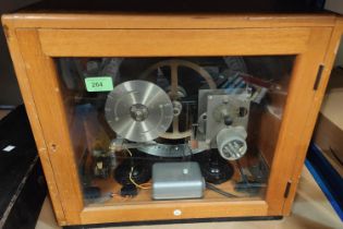 A 1960's school bell timer in glass cabinet