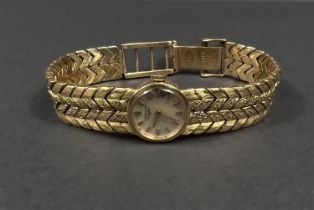 A Longines lady's wristwatch on 18 carat double chevron strap, gross weight 35.5gm