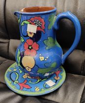 A Burslem jug and stand Arts & Crafts style and an Iznik style dish