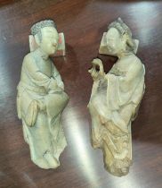 A pair of 18th century Chinese soap stone figures, male and female lying on pillows (female neck