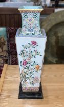 A Chinese vase of square tapering form with polychrome decoration of flowers and characters, on