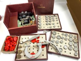 OMEGA: a cased factory press set with various tiers and further OMEGA watch makes accessories