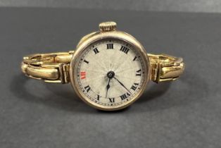 A 9ct hallmarked gold early 20th century ladies wristwatch on plated expanding bracelet