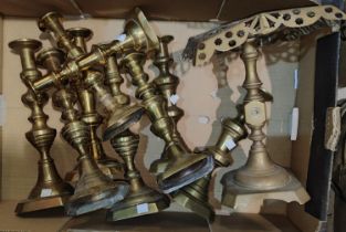 A selection of pairs and single Victorian candlesticks, a similar trivet