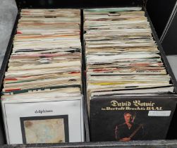 A carry case containing a collection of singles inc. David Bowie, John Lennon, Chubby Checker etc