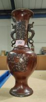 A Chinese bronze vase of baluster form with cast handles and relief decoration of flowers, birds