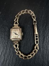 A mid 20th century ladies 'Everite' squared dial wrist watch on a 9 carat hallmarked gold strap. (