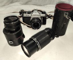 A Pentax K1000 SLR camera with three lenses, 80mm - 200mm, 28mm and 50mm