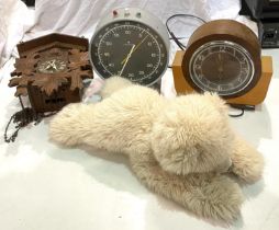 A Junghans Dark Room step clock; a cuckoo clock, another clock and a Steiff polar bear.