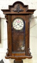 A 19th century Vienna wall clock in walnut case, spring driven, with strike