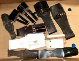 A collection of vintage and later, leather military bayonet frogs.