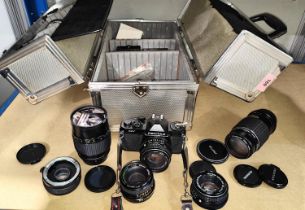 A Pentax MV SLR Camera, a selection of lenses of various sizes  in photographic carrying case.