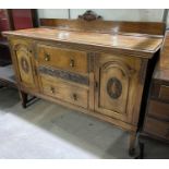 An early 20th century mahogany sideboard with 2 arch panel end cupboards and 2 central drawers on