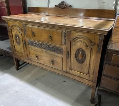 An early 20th century mahogany sideboard with 2 arch panel end cupboards and 2 central drawers on