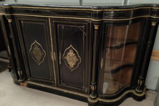 A 19th century ebonised serpentine front credenza with ormolu beading and mounts having 2 glazed