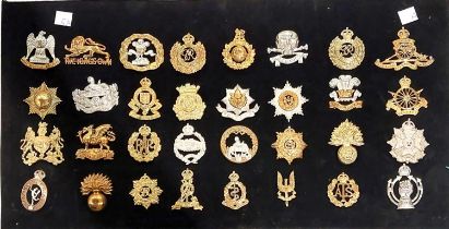 A collection of Military badges set on cardboard Cheshire Regiment etc