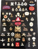 A collection of Military badges set on cardboard metal and cloth badges etc