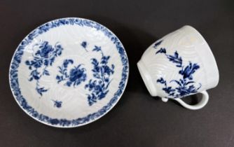 A First Period Worcester style porcelain in blue and white cup and saucer with floral decoration