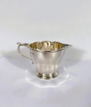 A hallmarked silver milk/cream jug of tapering ribbed form, Birmingham 1930, 6.5oz