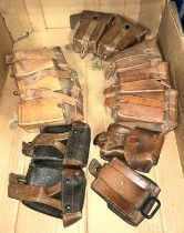 A collection of vintage leather military pouches.