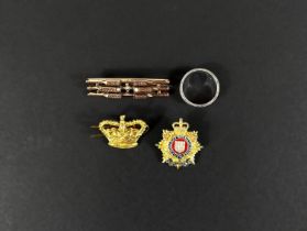 A yellow metal Edwardian three bar brooch set with seed pearls 4.7gm, two badges, a crown and a