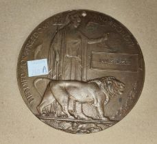 A WWI death plaque awarded to James Leslie (hole to top and other metal on reverse possibly to hang)