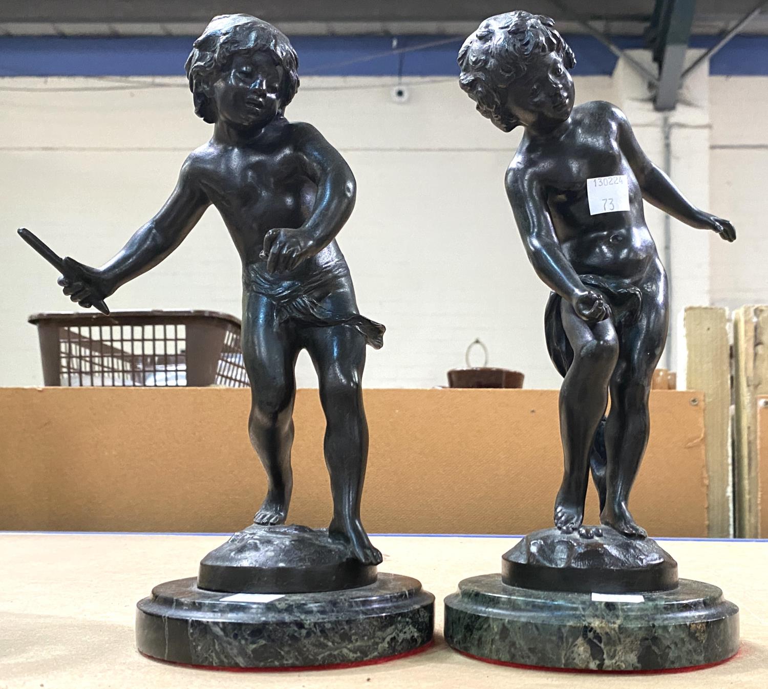After August Moreau, a pair of bronze figures of young boys playing, mounted on circular marble