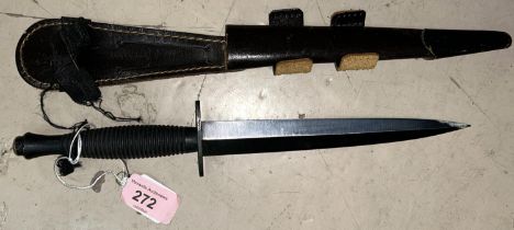 A Fairbairn - Sykes style fighting commando knife with blackened handle and blade, in a leather