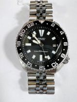 A Seiko automatic dive watch, steel case and bracelet, black dial and face