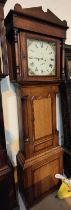 An early 19th century oak and mahogany longcase clock with architectural pediment and turned columns