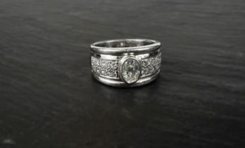 A gentleman's white metal dress ring with central oval brilliant cut diamond (8 x 5.8 x 3.6mm