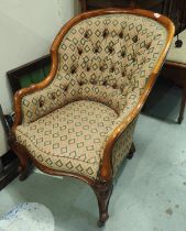 A Victorian walnut framed deeply buttoned armchair with rounded back