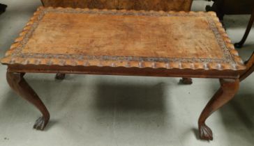 An oriental carved hardwood coffee table with rectangular top