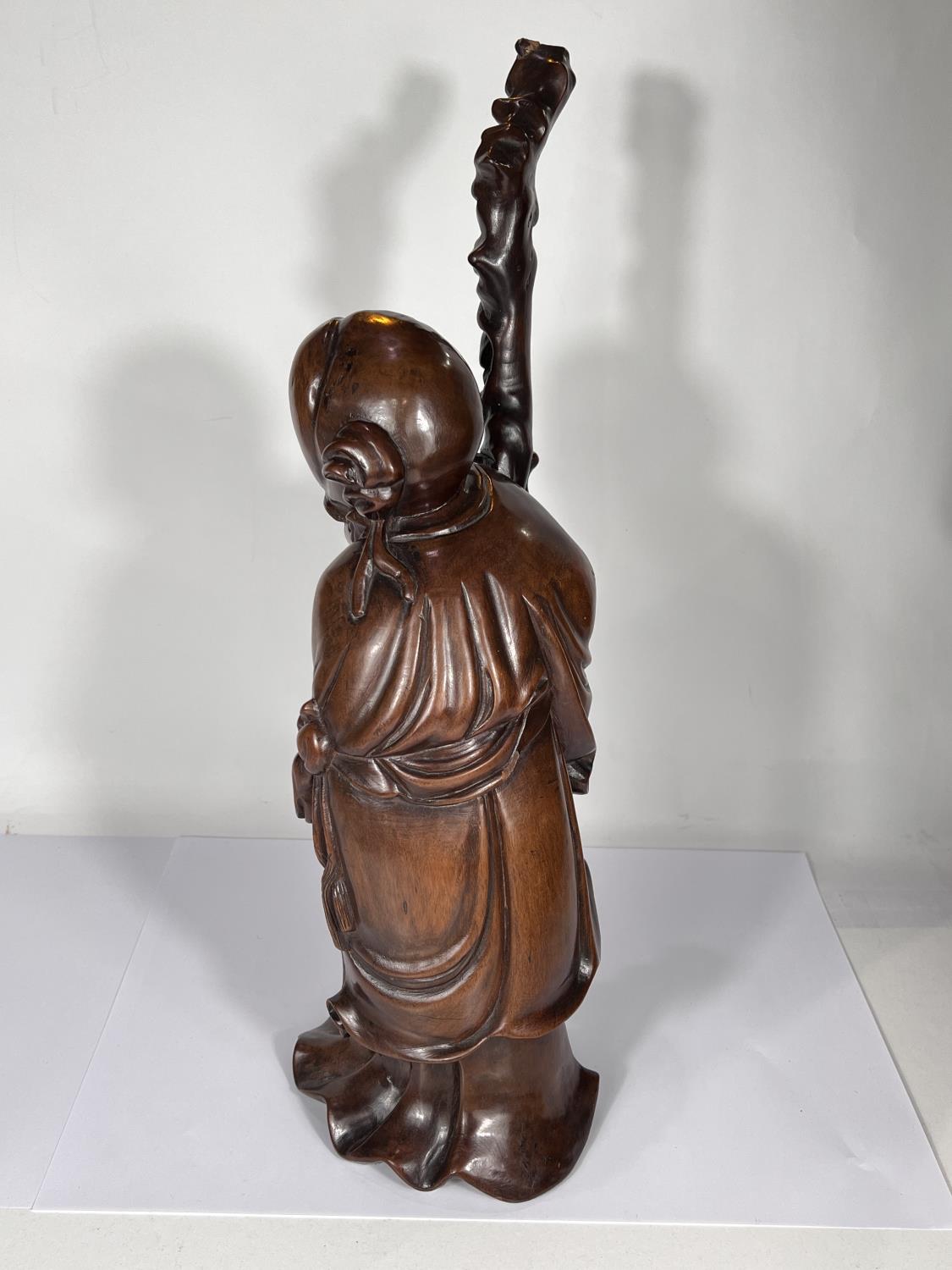 A Chinese hardwood carving of a sage with stick and fruit, ht. 50cm - Image 4 of 4